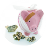 Piggy Bank with bandages, surrounded by crumpled dollar bills
